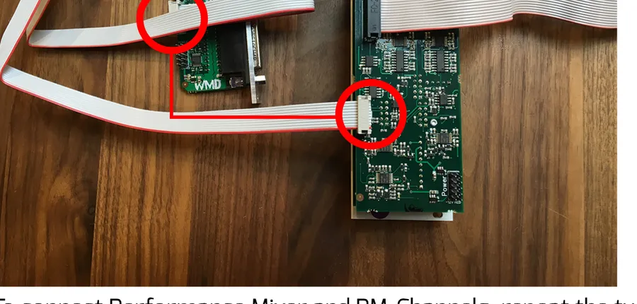 A PM-Channels module joined to the DB25 expander by a 10-pin ribbon cable. Red circles highlight the left-most middle header on PM-Channels and the header second from the bottom on the DB25 expander.